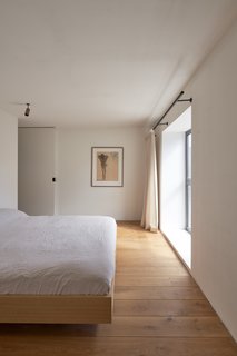 Oiled oak floors in the master suite provide continuity with the joinery downstairs.