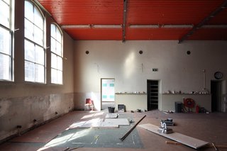 The firm preserved the gymnasium’s only striking architectural feature: a set of "monumental arched windows."