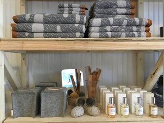 Toiletries and bath supplies include the Rainy Day towel collection by Donna Wilson, wool and leather tissue box covers by Graf Lantz, and West Third Brand perfumes.