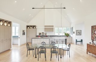 The kitchen features custom white oak kitchen cabinets stained light gray and Caesarstone rugged concrete countertops.