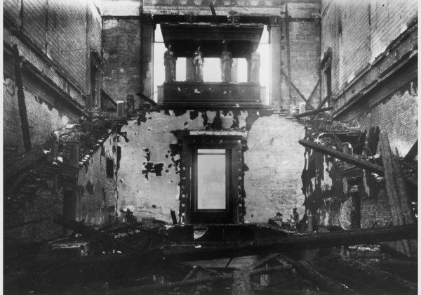 The staircase in November 1943, after the bombing. Following the war, the building was left exposed to the elements, which did further damage. The plaster figures seen here were not salvageable.