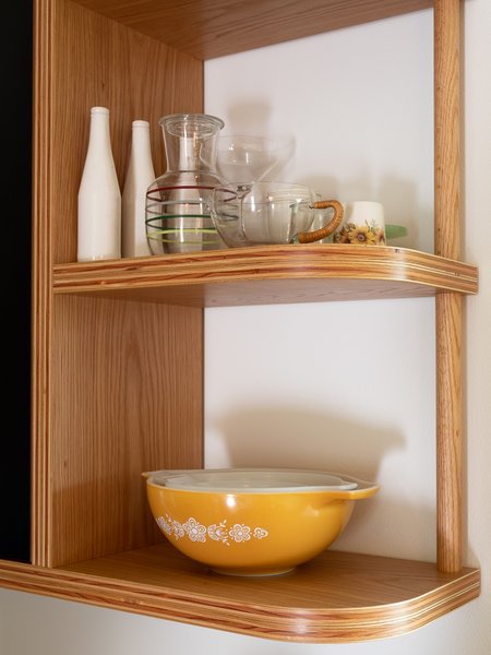 Exposed plywood shelving with a radial detail.