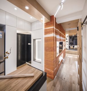 The designers wrapped the door in cabinetry to create more storage opportunities.