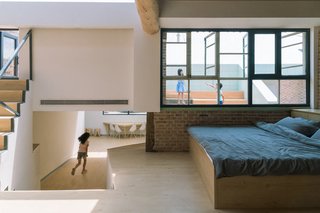 A corridor and exterior roof terraces connect the addition to the existing building.