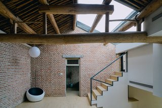 A skylight inset into the tiled roof brings light into the interior.