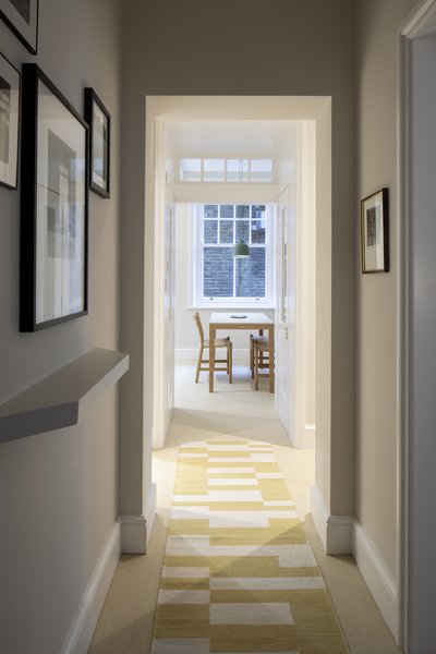 Now, the view from the front door is into the dining area. Note the angled shelf at the entry, a geometric detail which will be a reoccurring motif throughout.