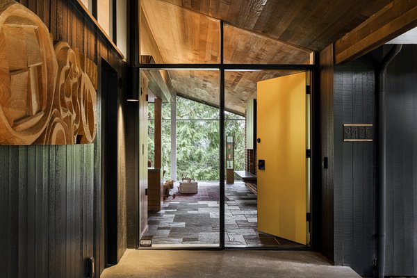 A bright-yellow door leads into the foyer and reveals the living room of the 3,630-square-foot home.
