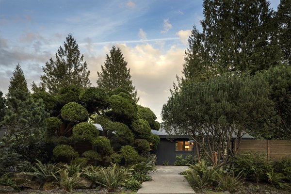 The home is tucked behind tranquil, mature landscaping.