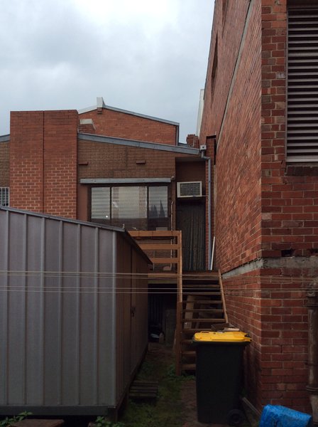 Before: The rear of the building had a rickety staircase that led to the workshop entrance.