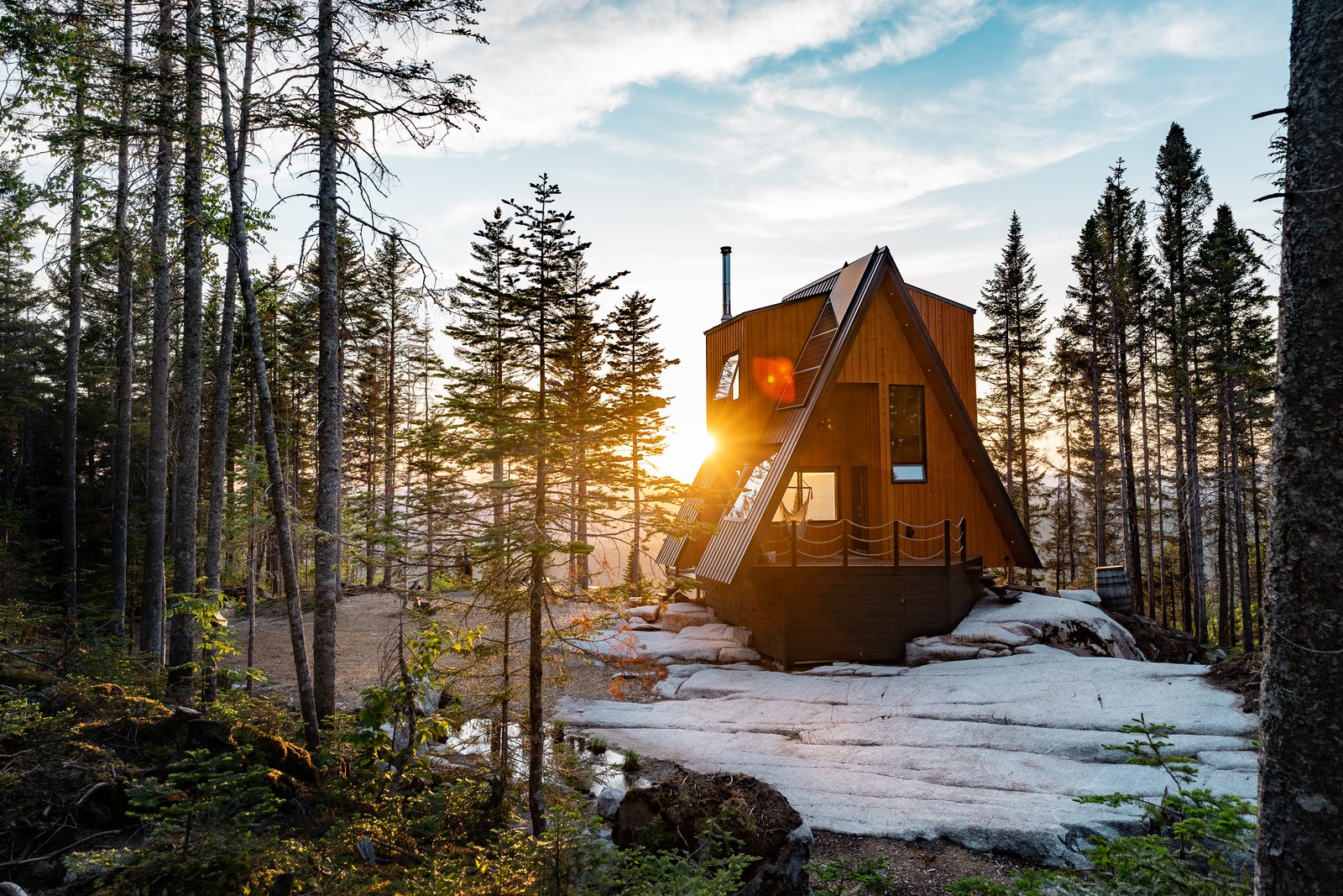 On one side of the A-frame, an empty volume tucked beneath the sloping roofline creates a sheltered porch with a hammock. Homes in Le Maelström are intended to be 