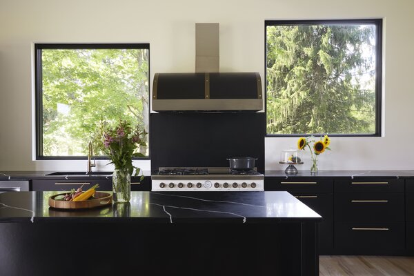 In the kitchen, black marble tops sharp black cabinetry.