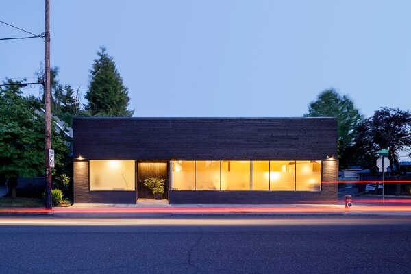 Rough cut cedar stained ebony joins the brick on the front façade.