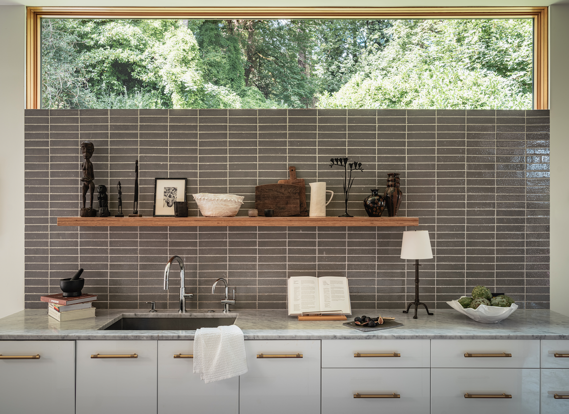 The backsplash tile is Dirk Elliot, and various decor items on the walls and shelves are from the couple’s travels in Indonesia, India, and Mexico.