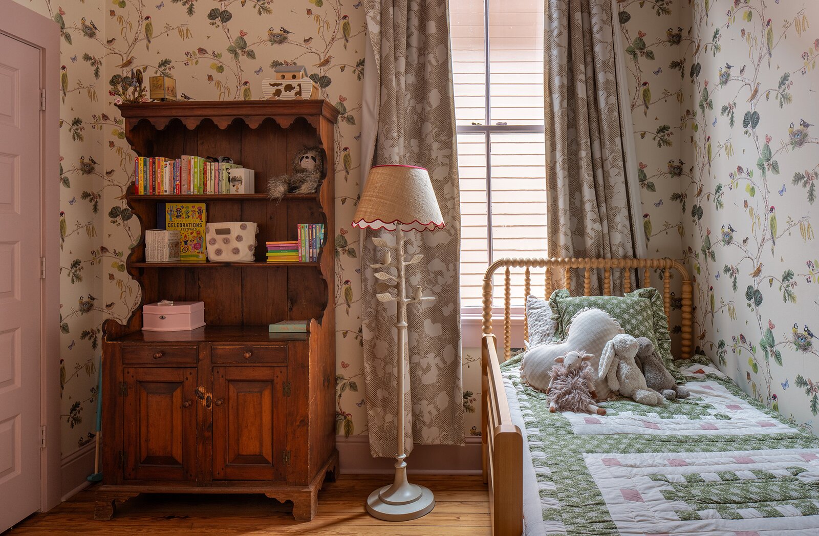 In another child’s room, Woodland Chorus wallpaper from Sanderson is combined with Batik paint from Benjamin Moore.