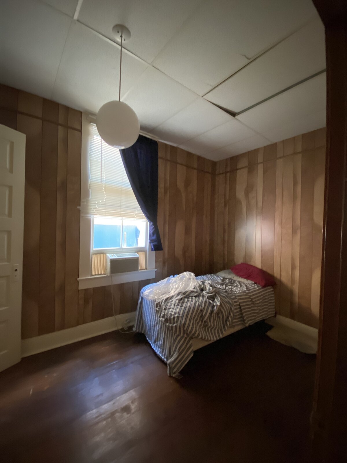 Before: A bedroom with the dropped ceiling that clued Seamus into the house having good bones underneath the dated finishes.