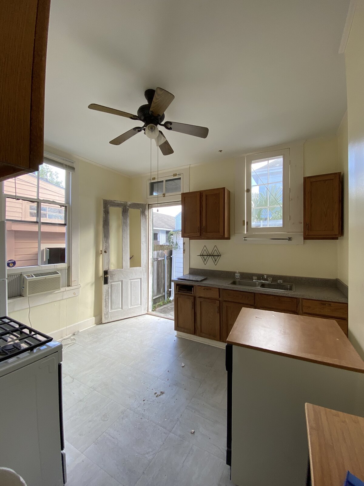 Before: The rear of the double shotgun home had two kitchens, both of which were removed, with one becoming the family room.