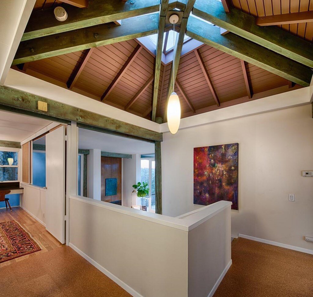 Before: The Jennings Residence was built in 1965. The entry has a distinct vaulted ceiling over the stairwell, with a skylight and expressed structure. 