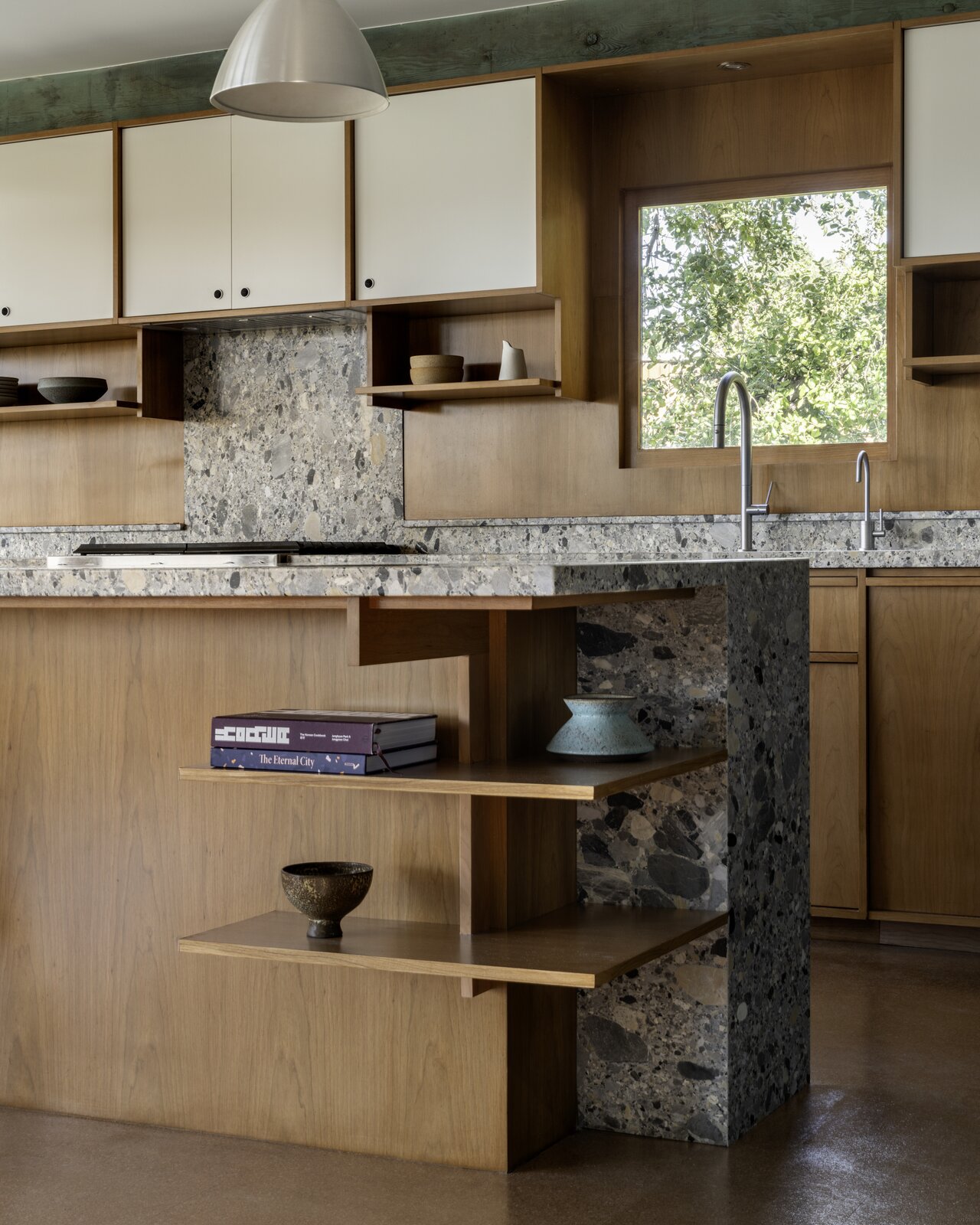 The cherry cabinetry throughout, including the kitchen island with the exposed corner, 