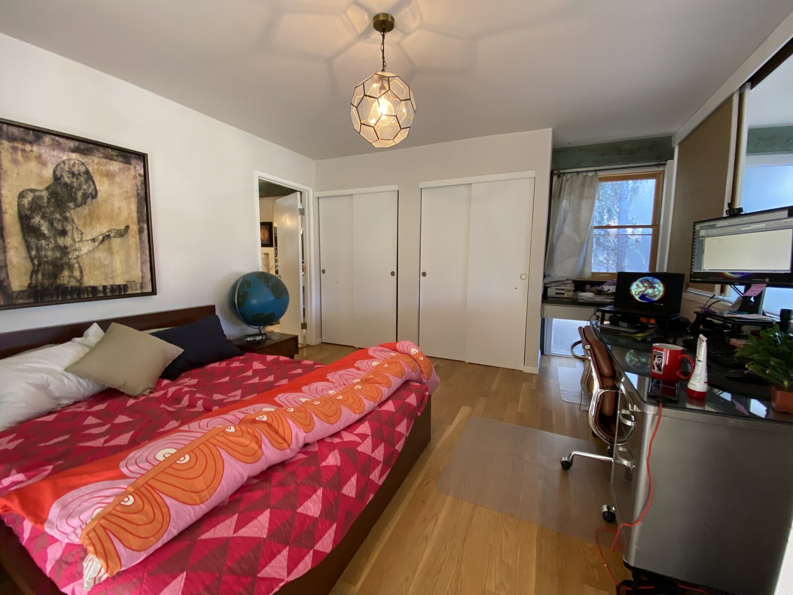Before: Original sliding doors allow the room to overlook the living room. Those were kept, but the design team reworked the closets and how they connect to the bathroom.