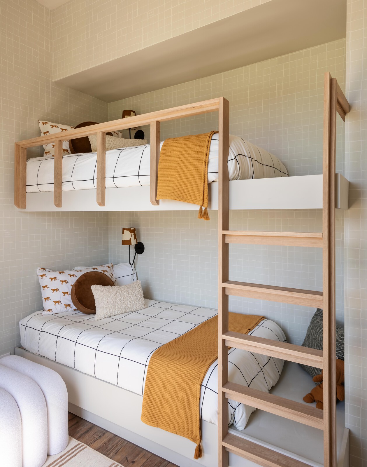 Joel built the custom bunk beds to fit the small footprint. The walls are covered in Lulu &amp; Georgia wallpaper.