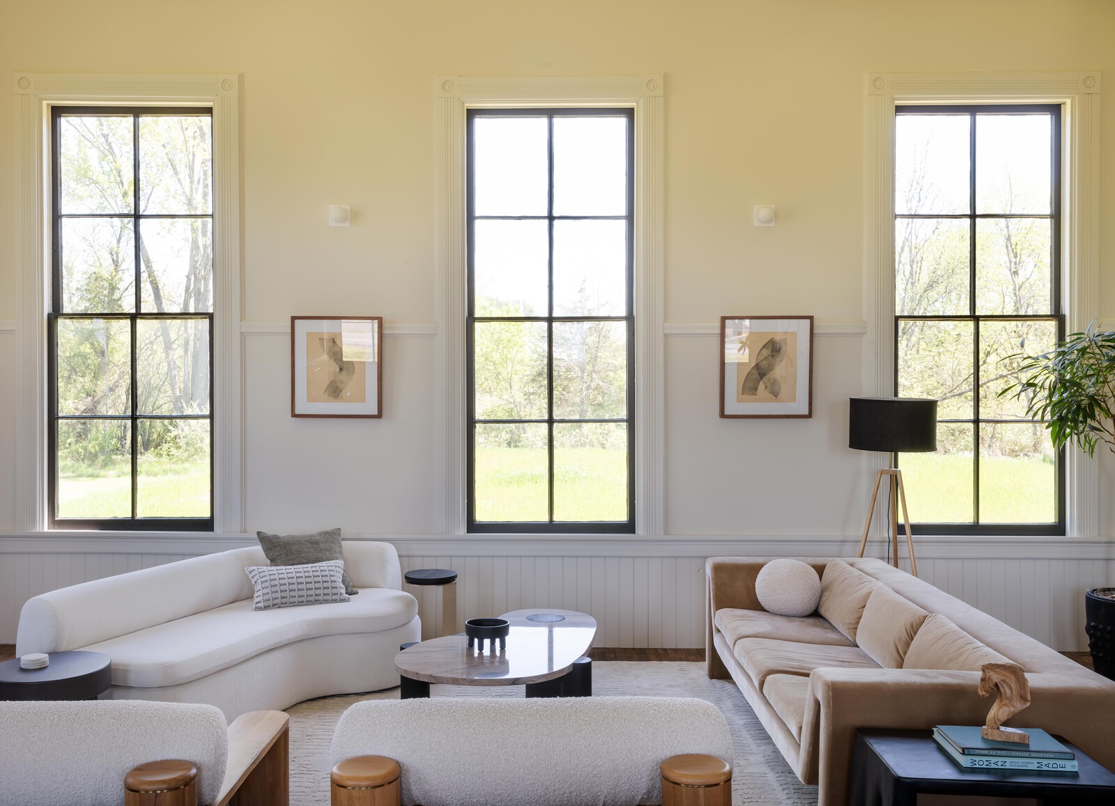 In the living room, a white sofa from Maria Yee and CB2 couch flank a custom coffee table designed and built by Joel. The walls are painted 