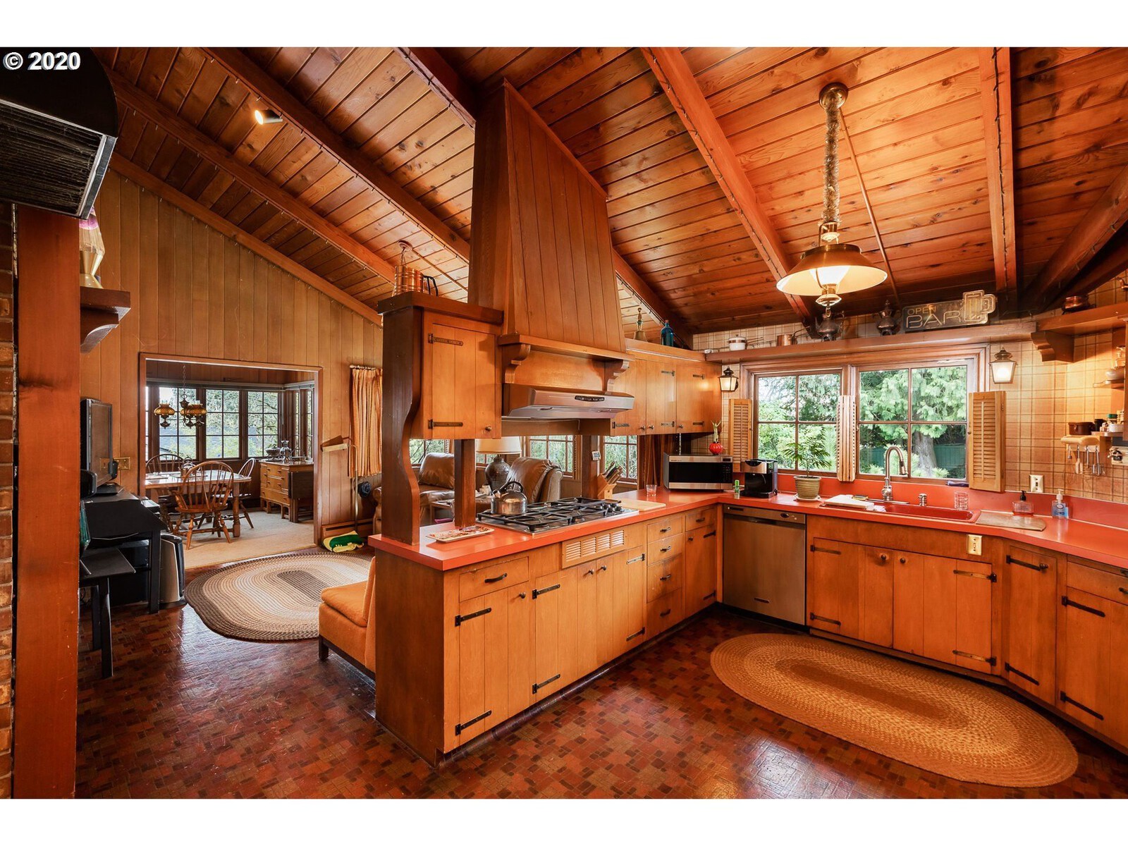 Before: The room had a great vaulted ceiling covered in wood, but the peninsula layout blocked the flow.