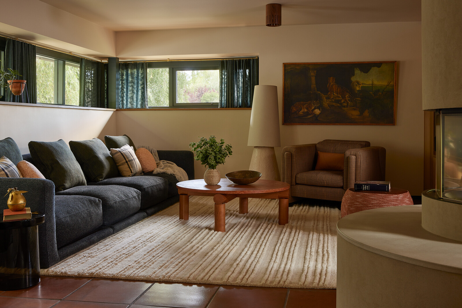 The floor has tile from Arto Ceramic via the Portland-based Tempest Tileworks, with a rug from Kush Rugs. A sculptural Bofred floor lamp sits with a Montauk sofa and coffee table by Michael Robbins.