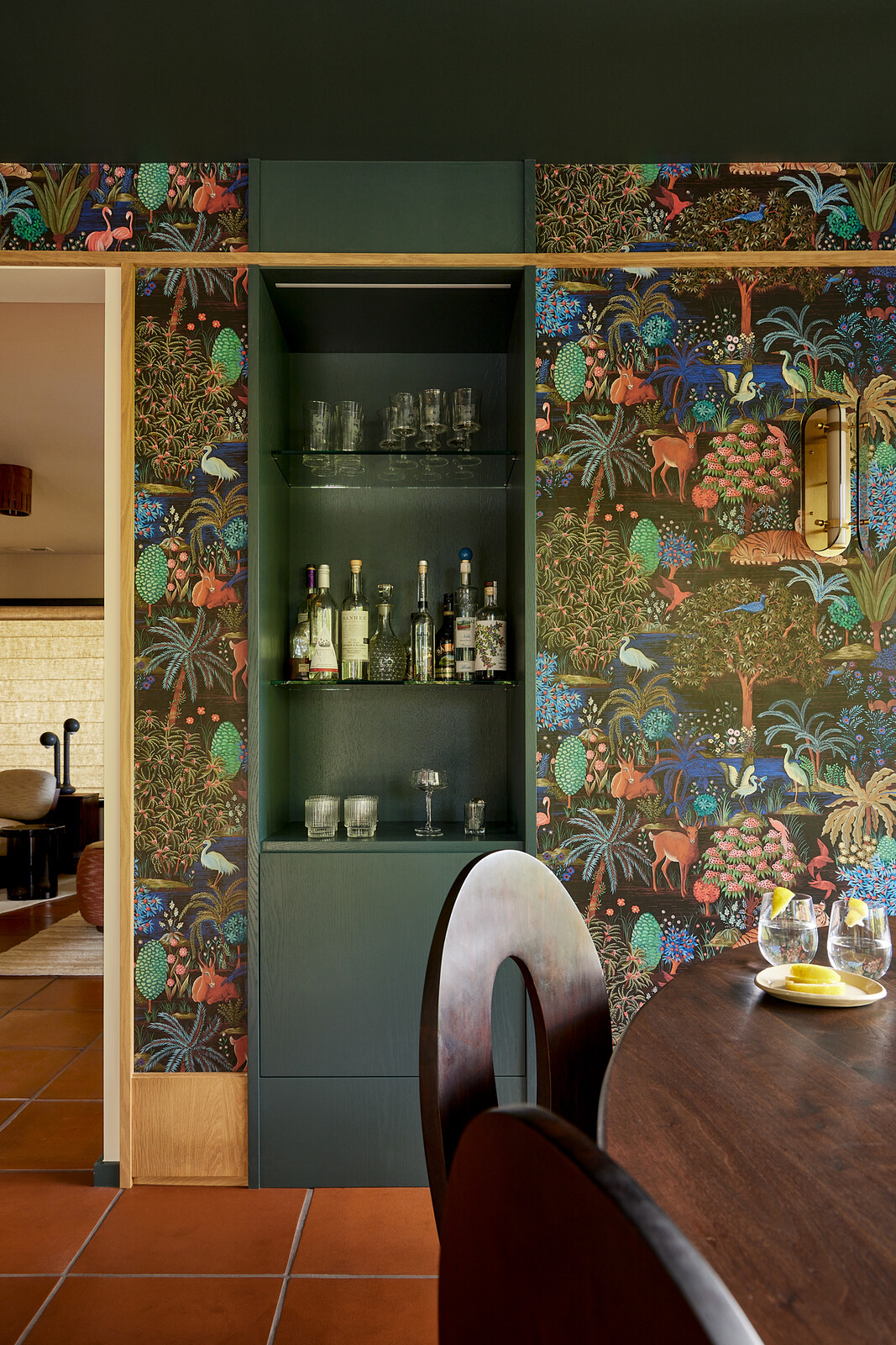 Pierre Frey wallpaper surrounds the built-in bar.