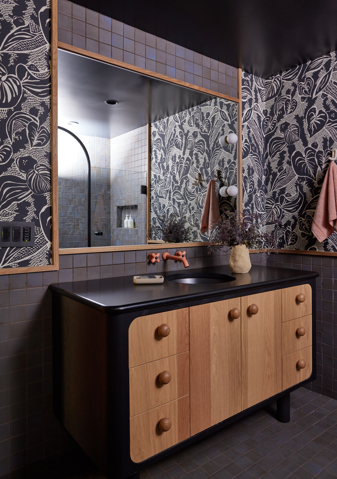 Bright Designlab designed the custom vanity, fabricated by Maple Key. The wallpaper is by Portland studio Makelike, and the pink tap is Fantini.