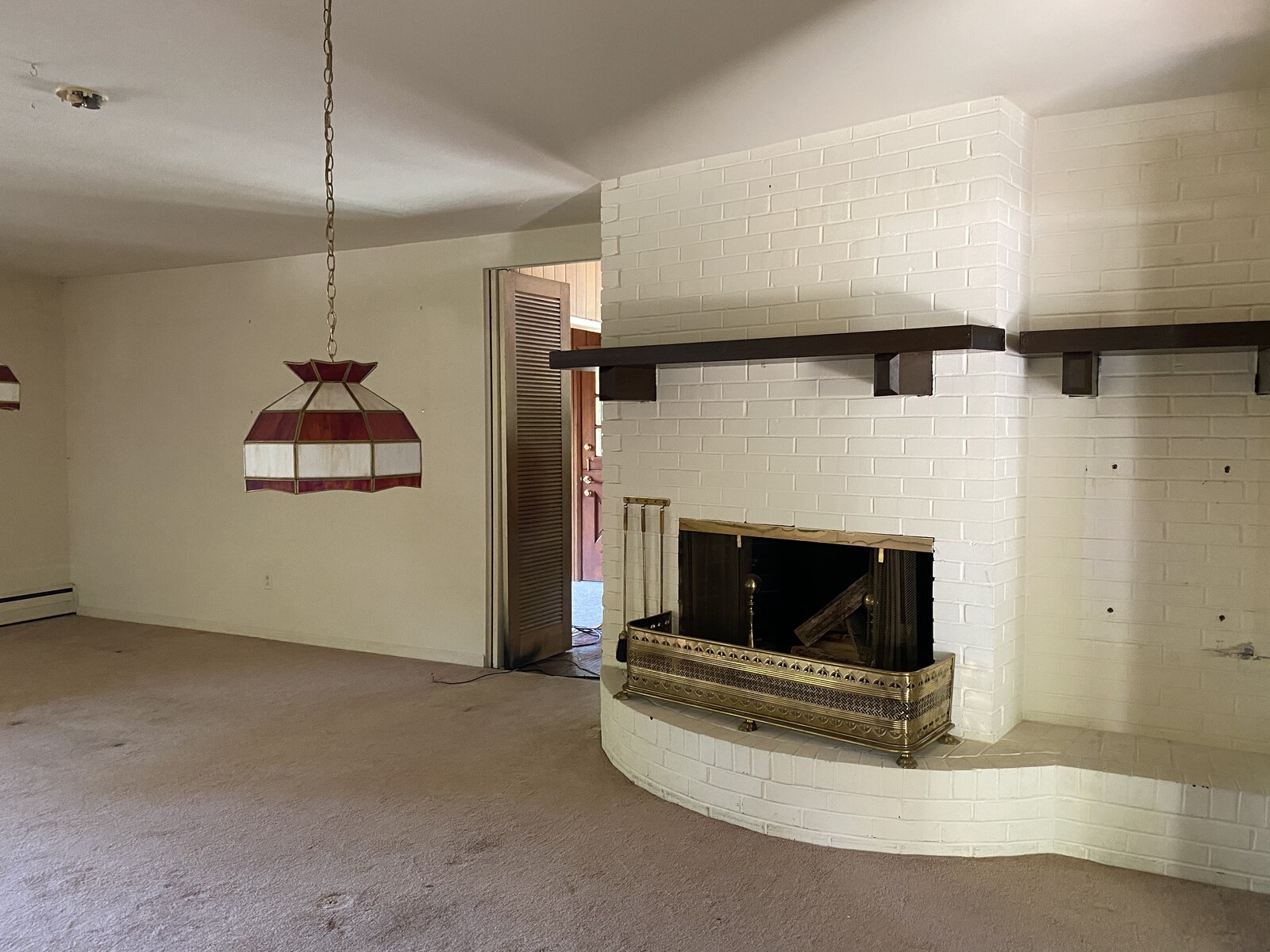 Before: Bright Designlab reworked the fireplace to ensure circulation happens all the way around it, which also better connects the kitchen to the living room.