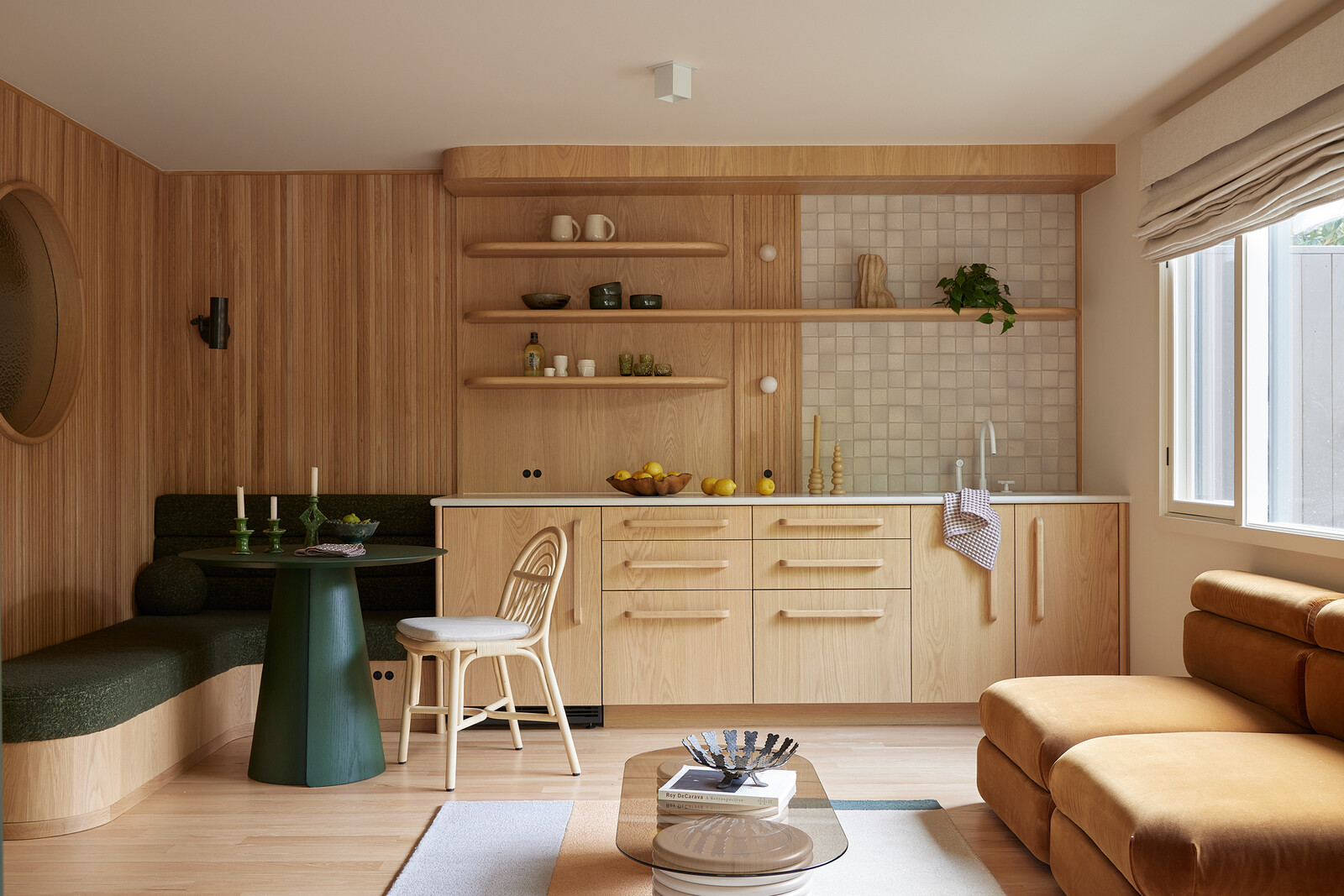 A semi-finished daylight basement is now an independent suite that can flex in use. Master Furniture Makers fabricated the custom-designed cabinetry, curved built-in seating, and wall treatment. Caesarstone ‘Fresh Concrete’ covers the kitchenette counters.