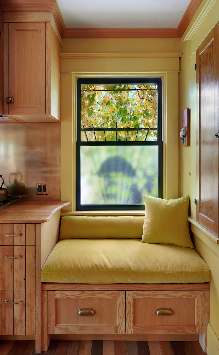 Stephanie detailed a built-in bench, which is now a favorite spot to sit with the cook, in order to fill in the wasted space below the window, using yellow velvet for the custom upholstery ($2000).