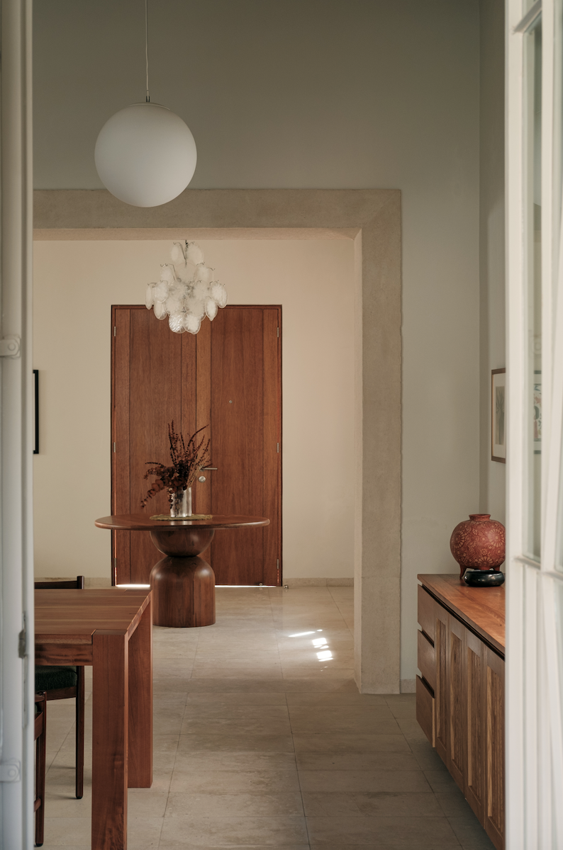 Catherine's Italian chandelier hangs in the front hall. The floors are marble from Mexico. "We wanted [the floors] to feel a little more natural,