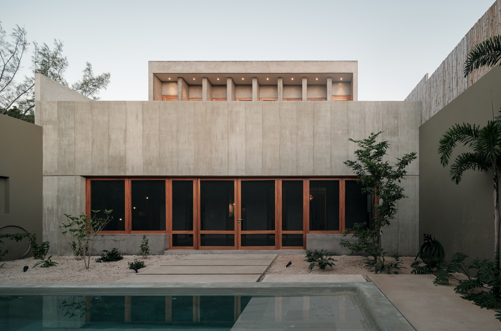 Since the screened porch was an addition to the original volume, the architects had it finished in channeled concrete to mark its difference.