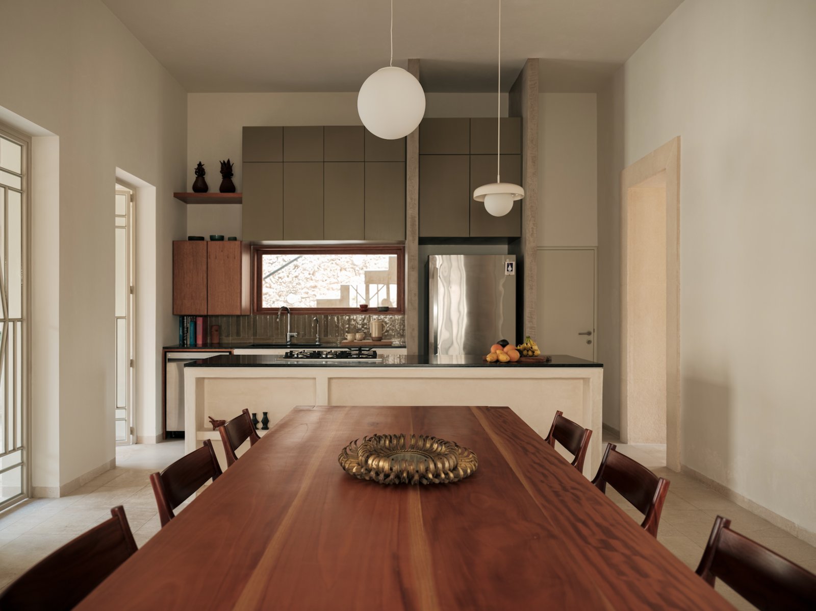 The green color on the kitchen cabinets echoes the exterior color.