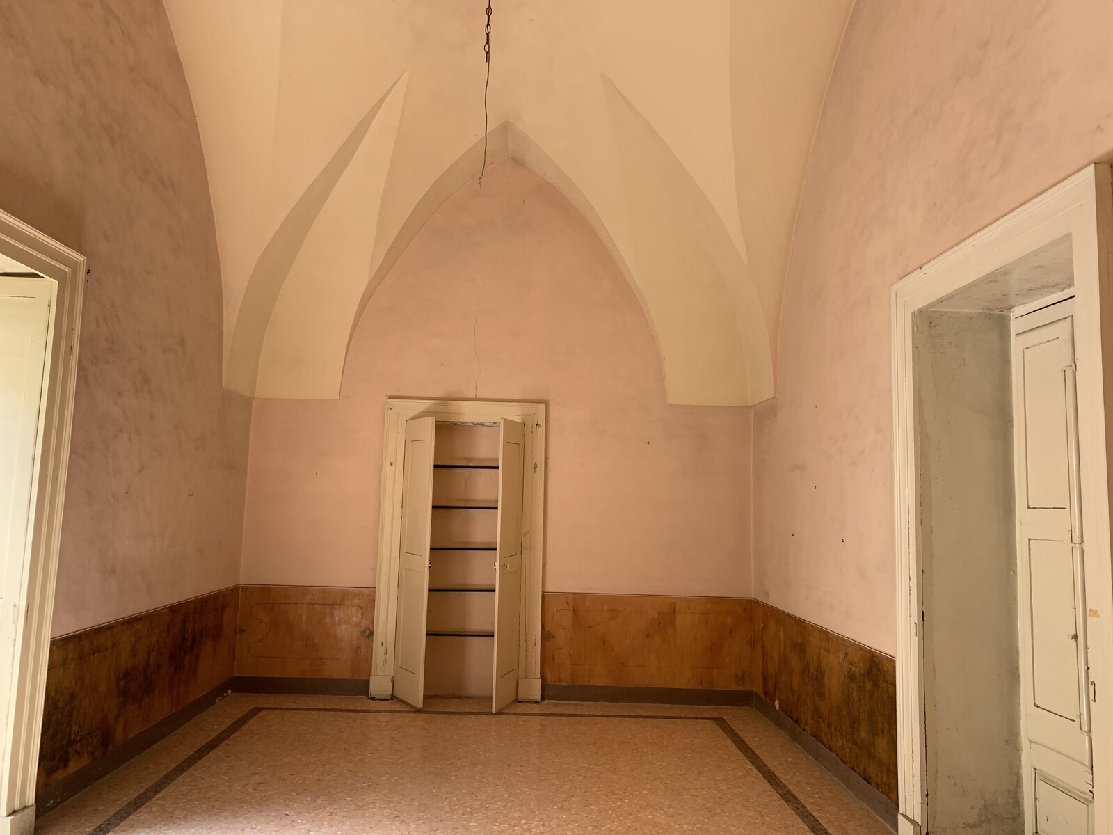 Before: Manuel Strebinger and Stefan Davids bought this historic palazzo in Nardò, Italy, with the goal of restoring the best historic features, like the star vault ceilings, and taking away the 70s finishes, like the pink walls here. "We didn't want to use too much strong color,