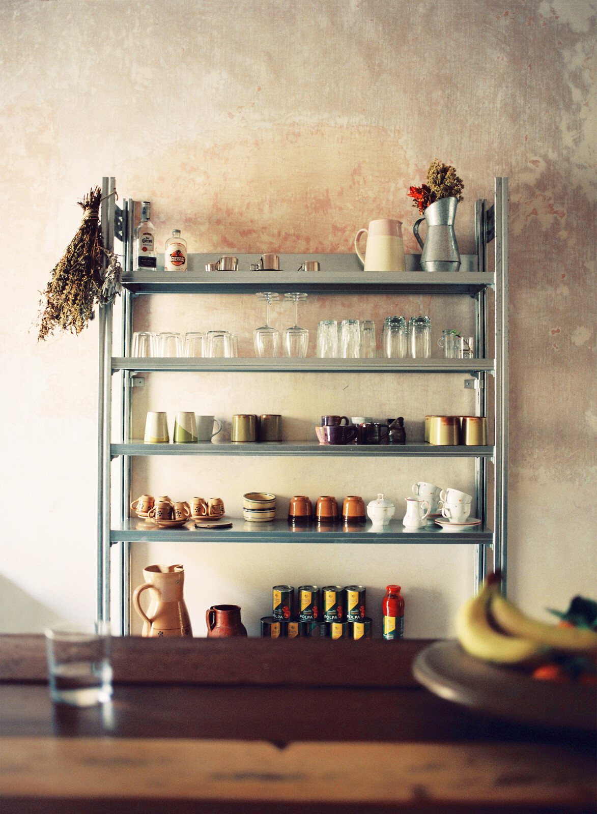 The galvanized steel shelving is from Situér Milano.
