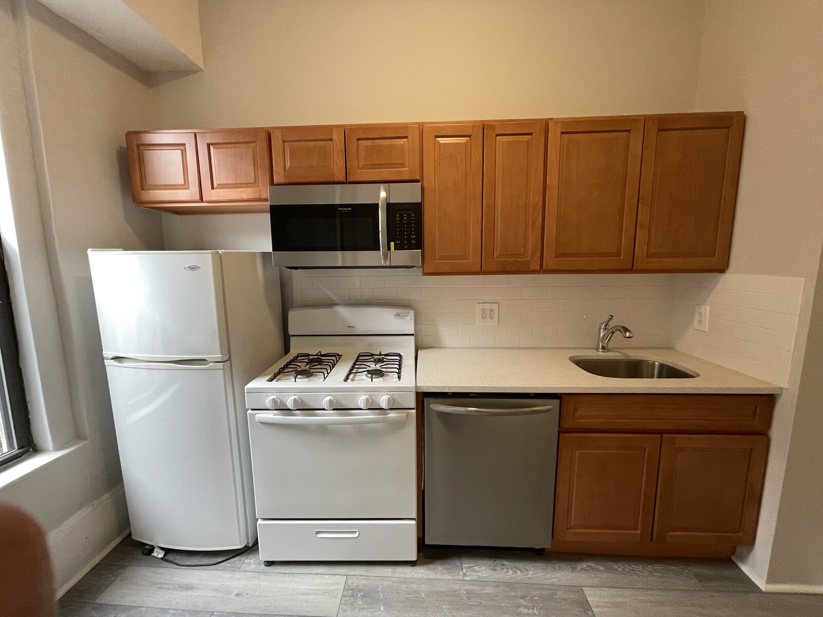 Before: The kitchen was too small and had inadequate storage, so a wall was removed to enlarge it.