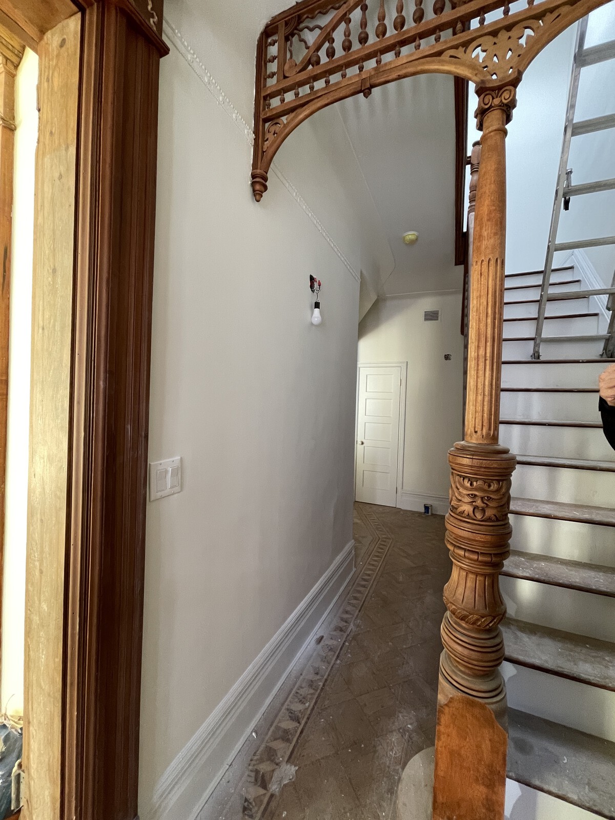 During: Refinishing the woodwork allows its details, like this face in the newel post, to become more pronounced.