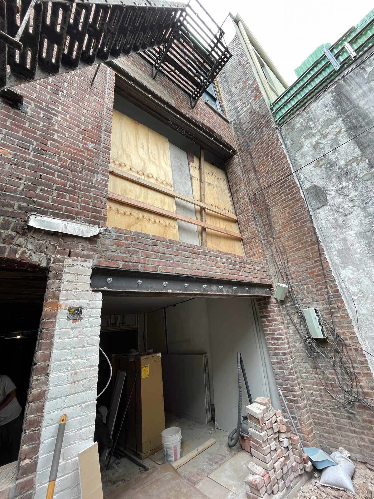 During: A big part of the budget was enlarging the openings in the rear facade for the glass doors in both units.