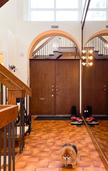 Before: Architect Bernard Rasch designed this modernist rowhouse, one of six, in 1977. Richard and Nicole Kuchinsky bought this one in 2018, with the goal of remodeling it for their family while keeping the distinct features, like the wall of smoked glass in the entry.