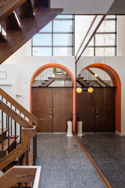 Ciot terrazzo tile now covers the entry floor. A Nuvo sconce is now mounted on the smoked glass.