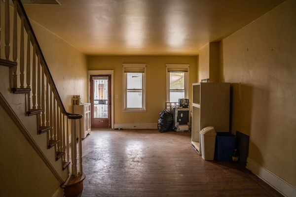 Before: The living room received new windows and flooring. The old floors were too far gone to save.