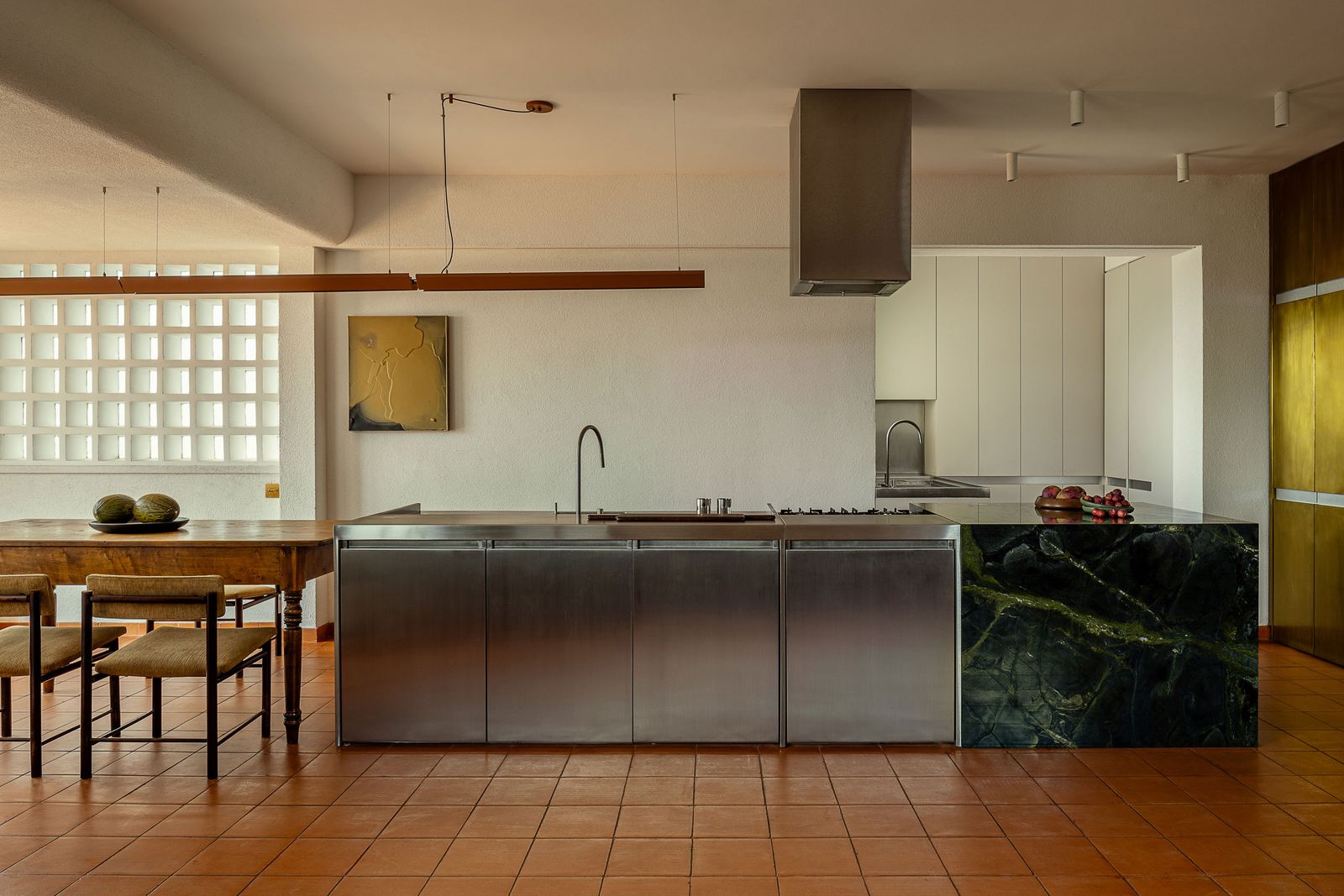 Underfoot, the architects added terracotta tile that runs from inside to out, creating further continuity and grounding the home in a natural material. Since being on MasterChef Brasil, Greg has been producing more Instagram tutorials with the new kitchen as set, with Fred and the children often pitching in to help behind the scenes.