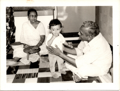 Vineet with his grandparents, Mr. DD Vora and Mrs. Gunvanti Vora, snacking in the kitchen. Mr. DD Vora designed and built the apartment in the 1950s in the Art Deco style. Art Deco, says Vineet now, was a wide-spread influence in Mumbai without being identified as such. "Interestingly, they were all following art, not knowing that they were doing art,