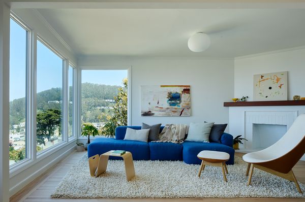 Bowman found the salvaged wood for the mantlepiece and gifted it to the couple on completion of the project. The Uchiwa Lounge Chair and Ottoman, and Mags Soft Low Sofa are both by Hay, with a Flos light overhead. The painting above the sofa is by Georgia Young and the painting on the fireplace is by Solee Darrell.