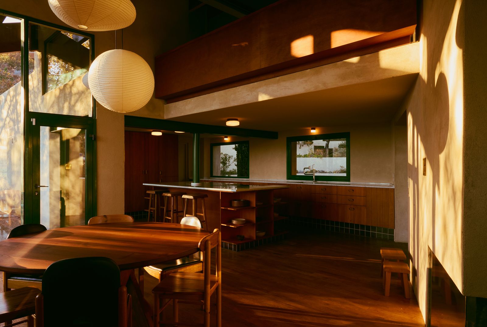 The original upstairs cabinet was refinished, and new cabinets in the kitchen were designed in the same Beech wood with a cinnamon-colored oil to be consistent. The vertical detailing earmarks that they are new insertions.