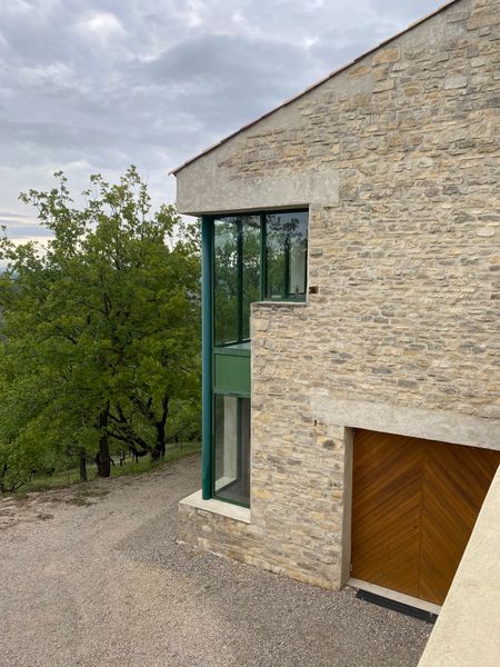 Before: The architects appreciated and preserved the home's original details, like the thick walls and green metal windows. This building had a garage with a lot of unused space.