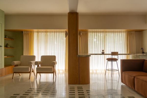A custom coffee bar anchors one side of the living room, placed before the expanded windows. The bar can double as a serving area when the couple entertains.