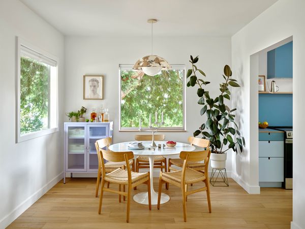 The Maru Pendant from Cedar & Moss hangs over a Tulip table with a marble top from DWR. The hutch is from Mustard Made.